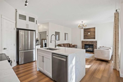 366 Bridleridge View Sw, Calgary, AB - Indoor Photo Showing Kitchen With Fireplace With Upgraded Kitchen
