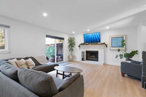 53 Riverside Crescent Se, Calgary, AB - Indoor Photo Showing Living Room With Fireplace