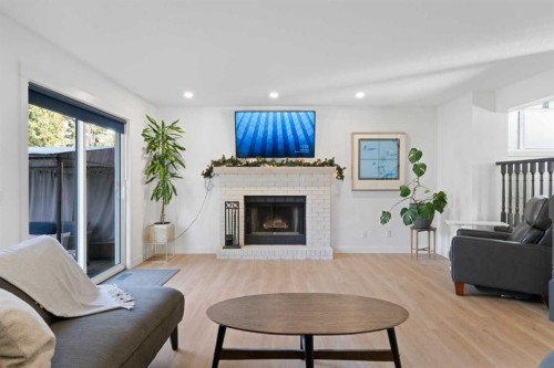 53 Riverside Crescent Se, Calgary, AB - Indoor Photo Showing Living Room With Fireplace