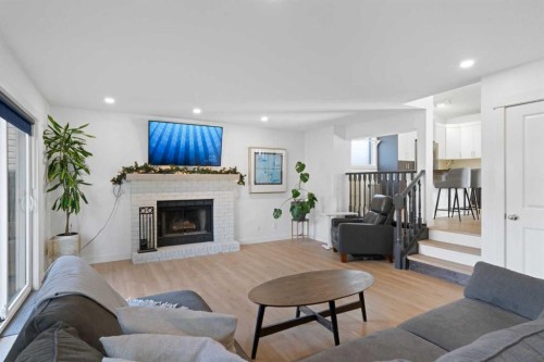 53 Riverside Crescent Se, Calgary, AB - Indoor Photo Showing Living Room With Fireplace
