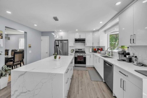 303 Ranchridge Bay Nw, Calgary, AB - Indoor Photo Showing Kitchen With Stainless Steel Kitchen With Double Sink With Upgraded Kitchen