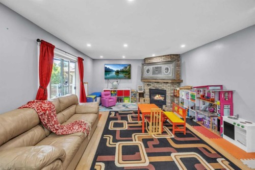 303 Ranchridge Bay Nw, Calgary, AB - Indoor Photo Showing Living Room With Fireplace