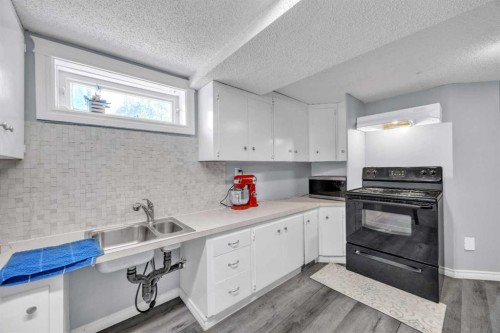 303 Ranchridge Bay Nw, Calgary, AB - Indoor Photo Showing Kitchen With Double Sink