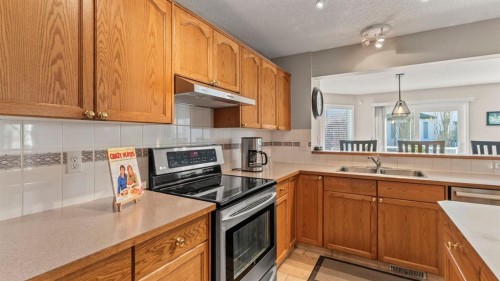227 Rocky Ridge Close Nw, Calgary, AB - Indoor Photo Showing Kitchen With Double Sink