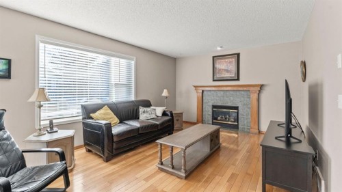 227 Rocky Ridge Close Nw, Calgary, AB - Indoor Photo Showing Living Room With Fireplace