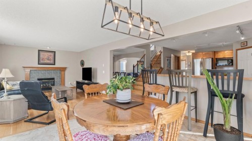 227 Rocky Ridge Close Nw, Calgary, AB - Indoor Photo Showing Dining Room With Fireplace