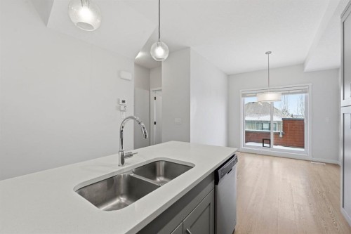 84 Shawnee Common Sw, Calgary, AB - Indoor Photo Showing Kitchen With Double Sink