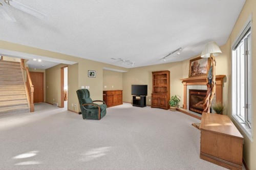 206 Arbour Cliff Close Nw, Calgary, AB - Indoor With Fireplace