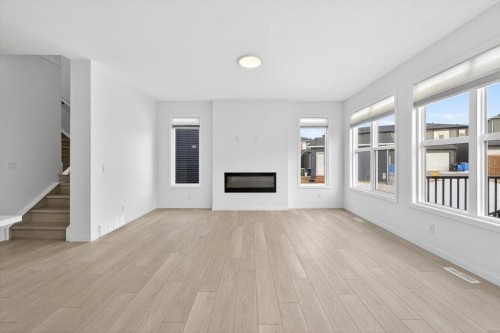 392 Carringvue Place Nw, Calgary, AB - Indoor Photo Showing Living Room With Fireplace