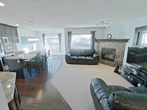 656 Cranston Drive Se, Calgary, AB - Indoor Photo Showing Living Room With Fireplace