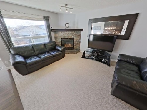 656 Cranston Drive Se, Calgary, AB - Indoor Photo Showing Living Room With Fireplace