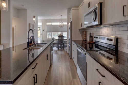 1601 Chinook Gate Drive Sw, Airdrie, AB - Indoor Photo Showing Kitchen With Double Sink With Upgraded Kitchen