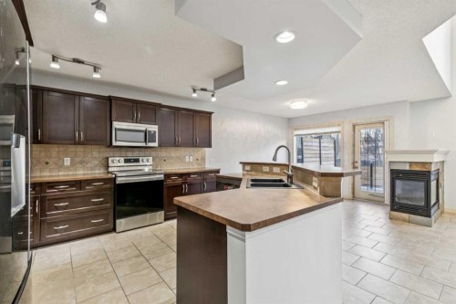 305 Tuscany Vista Road Nw, Calgary, AB - Indoor Photo Showing Kitchen With Double Sink