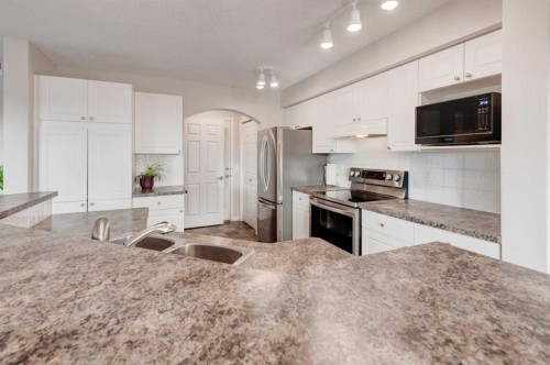 45 Cougarstone Place Sw, Calgary, AB - Indoor Photo Showing Kitchen With Double Sink With Upgraded Kitchen