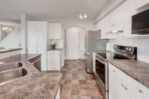 45 Cougarstone Place Sw, Calgary, AB - Indoor Photo Showing Kitchen With Double Sink