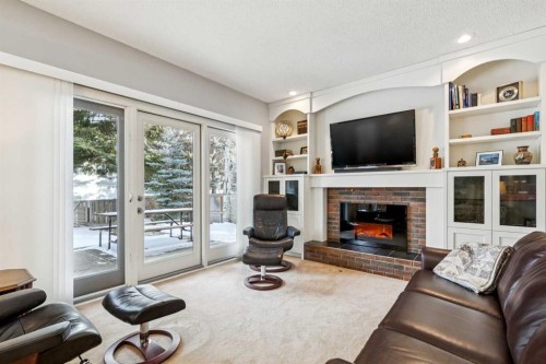 212 Oakside Circle Sw, Calgary, AB - Indoor Photo Showing Living Room With Fireplace