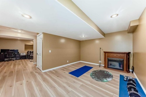 158 Invermere Drive, Chestermere, AB - Indoor Photo Showing Other Room With Fireplace