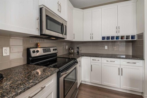 390 River Heights Crescent, Cochrane, AB - Indoor Photo Showing Kitchen With Stainless Steel Kitchen With Upgraded Kitchen