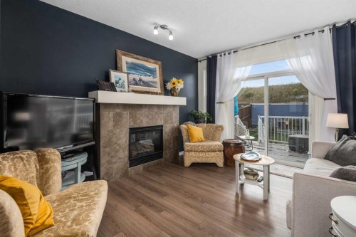 390 River Heights Crescent, Cochrane, AB - Indoor Photo Showing Living Room With Fireplace