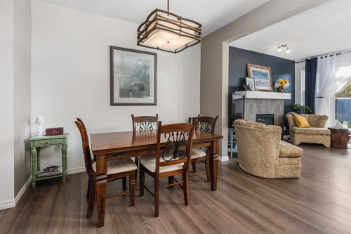 390 River Heights Crescent, Cochrane, AB - Indoor Photo Showing Dining Room With Fireplace