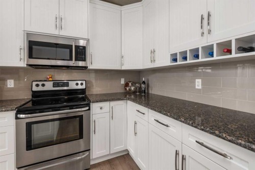 390 River Heights Crescent, Cochrane, AB - Indoor Photo Showing Kitchen With Stainless Steel Kitchen With Upgraded Kitchen