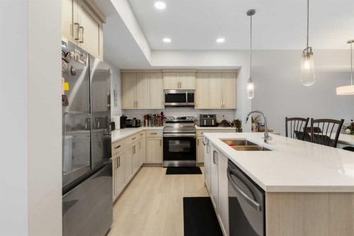 405-20295 Seton Way Se, Calgary, AB - Indoor Photo Showing Kitchen With Stainless Steel Kitchen With Double Sink With Upgraded Kitchen