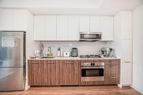 1313-730 2, Calgary, AB - Indoor Photo Showing Kitchen With Stainless Steel Kitchen