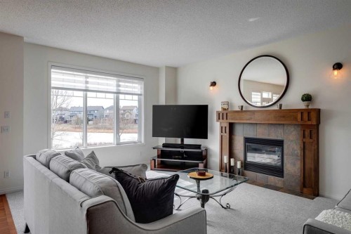 15 Copperfield Close Se, Calgary, AB - Indoor Photo Showing Living Room With Fireplace