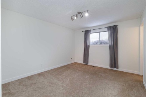 256 Queen Tamara Way Se, Calgary, AB - Indoor Photo Showing Other Room