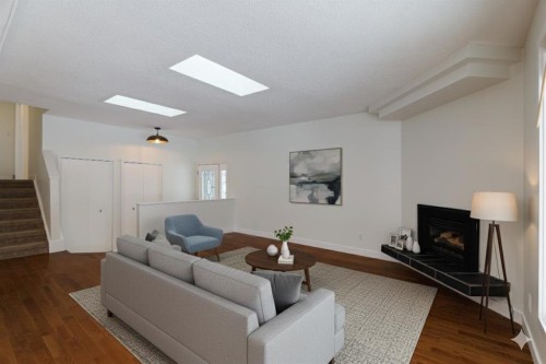 256 Queen Tamara Way Se, Calgary, AB - Indoor Photo Showing Living Room With Fireplace