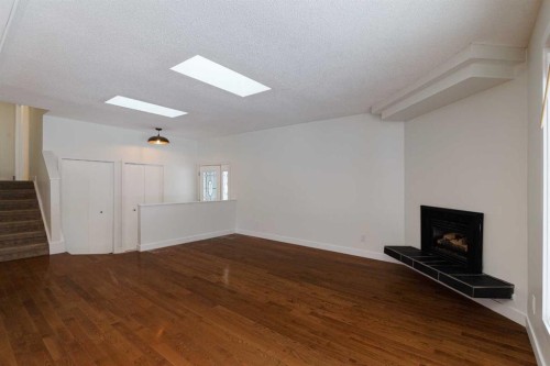 256 Queen Tamara Way Se, Calgary, AB - Indoor Photo Showing Other Room With Fireplace