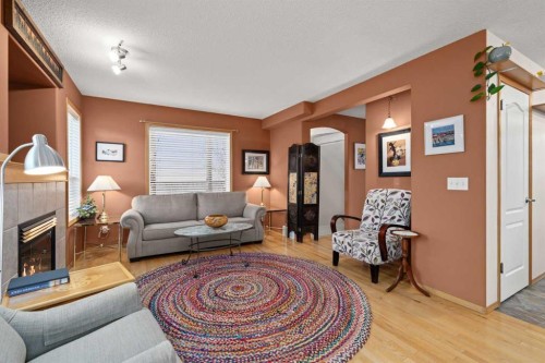 113 Sheep River Drive, Okotoks, AB - Indoor Photo Showing Living Room With Fireplace