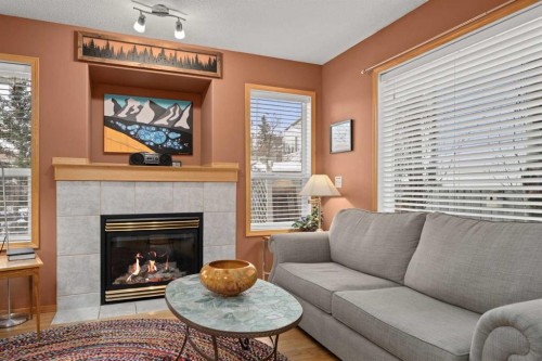 113 Sheep River Drive, Okotoks, AB - Indoor Photo Showing Living Room With Fireplace