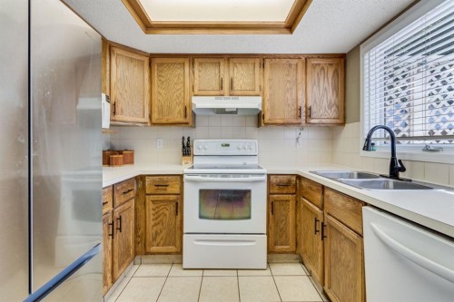 212 Mckerrell Way Se, Calgary, AB - Indoor Photo Showing Kitchen With Double Sink