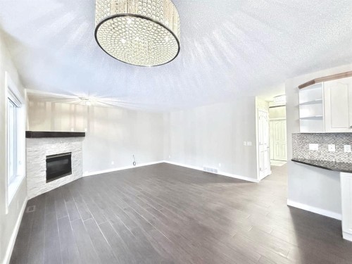 161 Springbank Place Sw, Calgary, AB - Indoor Photo Showing Other Room With Fireplace