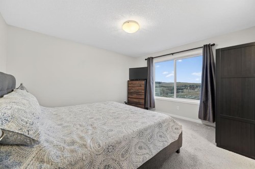 73 Fireside Cove, Cochrane, AB - Indoor Photo Showing Bedroom