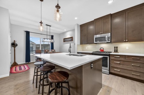 73 Fireside Cove, Cochrane, AB - Indoor Photo Showing Kitchen With Stainless Steel Kitchen With Double Sink With Upgraded Kitchen