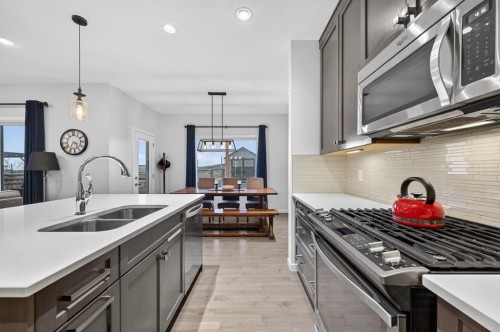 73 Fireside Cove, Cochrane, AB - Indoor Photo Showing Kitchen With Double Sink With Upgraded Kitchen