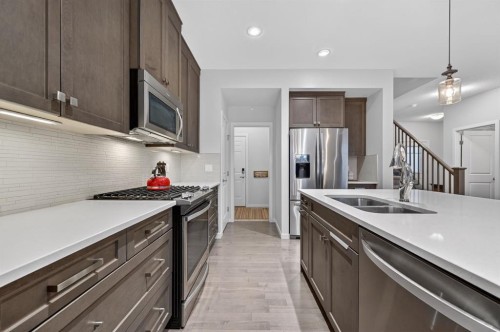 73 Fireside Cove, Cochrane, AB - Indoor Photo Showing Kitchen With Stainless Steel Kitchen With Double Sink With Upgraded Kitchen