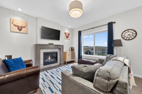 73 Fireside Cove, Cochrane, AB - Indoor Photo Showing Living Room With Fireplace