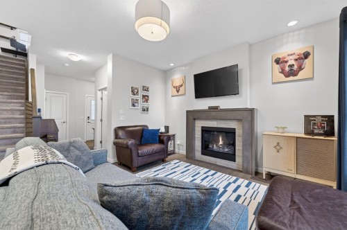 73 Fireside Cove, Cochrane, AB - Indoor Photo Showing Living Room With Fireplace