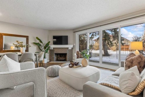 3-2212 Paliswood Road Sw, Calgary, AB - Indoor Photo Showing Living Room With Fireplace