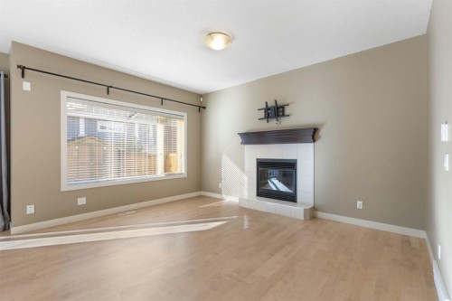 328 Silverado Plains Circle Sw, Calgary, AB - Indoor Photo Showing Living Room With Fireplace