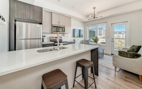 35 Spring Creek Common Sw, Calgary, AB - Indoor Photo Showing Kitchen With Double Sink With Upgraded Kitchen