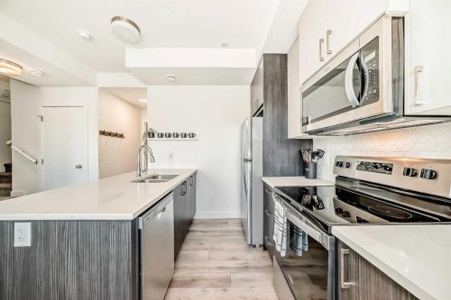 35 Spring Creek Common Sw, Calgary, AB - Indoor Photo Showing Kitchen With Double Sink With Upgraded Kitchen