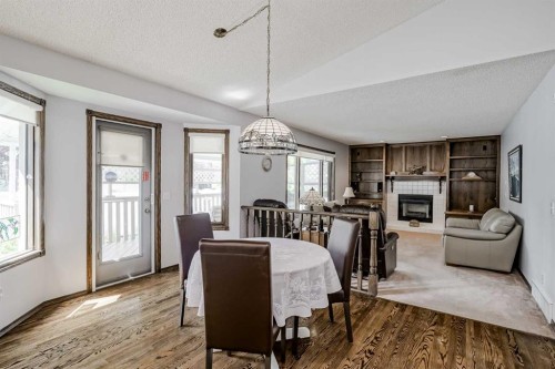 14319 Evergreen Street Sw, Calgary, AB - Indoor Photo Showing Dining Room With Fireplace