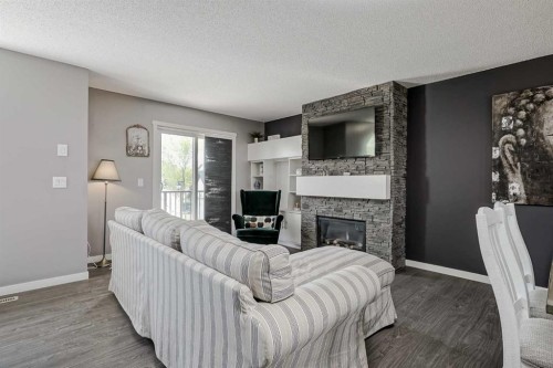 313 Copperpond Landing Se, Calgary, AB - Indoor Photo Showing Living Room With Fireplace