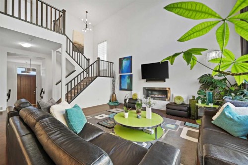 129 Springbluff Boulevard Sw, Calgary, AB - Indoor Photo Showing Other Room With Fireplace