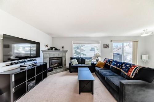 8-122 Bow Ridge Crescent, Cochrane, AB - Indoor Photo Showing Living Room With Fireplace