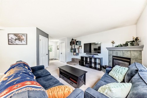 8-122 Bow Ridge Crescent, Cochrane, AB - Indoor Photo Showing Living Room With Fireplace